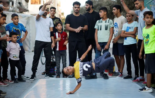 A Palestinian boy performs breakdance at a street in Nusseirat refugee camp in central Gaza Strip on October 14, 2022. (Photo by Ibraheem Abu Mustafa/Reuters)