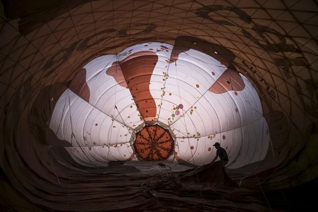 A hot air balloon is prepared for a flight during an international hot air balloon festival at Maayan Harod National park in northern Israel September 30, 2015. (Photo by Baz Ratner/Reuters)