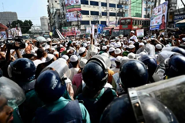 Police block Islami Andolan Bangladesh activists marching along a street during a protest demanding compulsory Islamic education in the national education curriculum in Dhaka on November 10, 2022. (Photo by Munir Uz Zaman/AFP Photo)