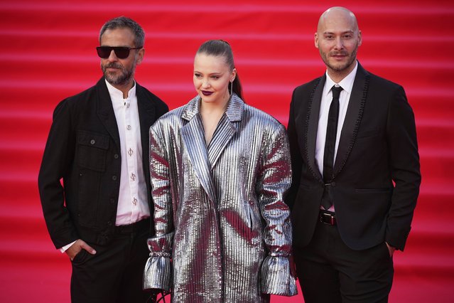 Short film competition jury members, from left, Turkish actor and director Erkan Kolcak Kostendil, Russian actor Yulia Khlynina and Italian actor Fabio Massa pose for photographers upon arrival for the closing ceremony of the 47th Moscow International Film Festival in Moscow, Russia, Thursday, April 24, 2025. (Photo by Pavel Bednyakov/AP Photo)