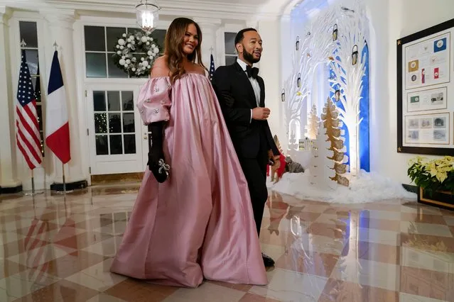 American model and television personality Chrissy Teigen, left, and American singer-songwriter John Legend arrive for the State Dinner with President Joe Biden and French President Emmanuel Macron at the White House in Washington, Thursday, December 1, 2022. (Photo by Susan Walsh/AP Photo)