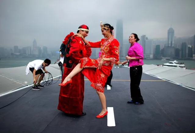 Competitors dance before the Hong Kong skyline as they take part in a Red Bull “Flugtag” event in the West Kowloon district of the city. (Photo by Ed Jones/AFP Photo)