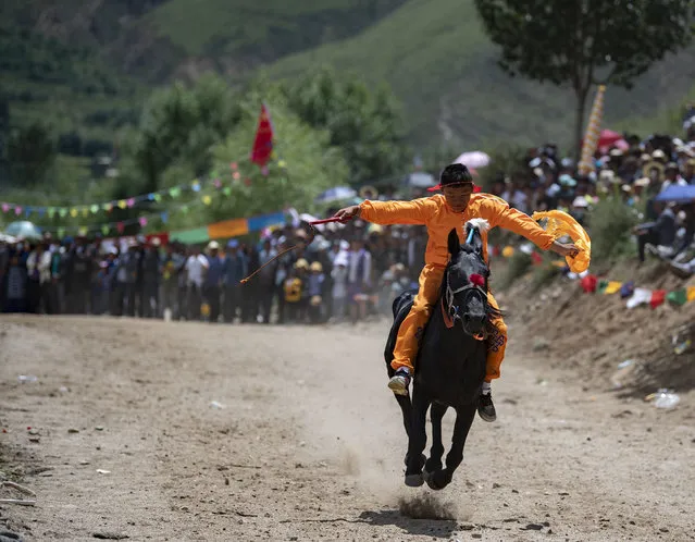 A rider competes during a horse race in Lhasa, southwest China's Tibet Autonomous Region on August 8, 2020. (Photo by Xinhua News Agency/Rex Features/Shutterstock)