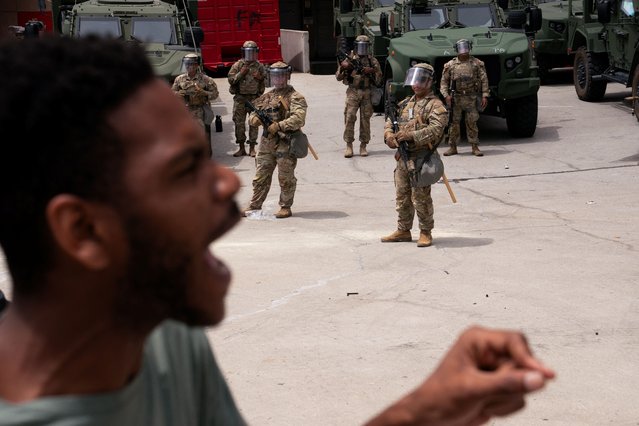 A protester shouts as California National Guard personnel stand outside the Edward R. Roybal federal building after their deployment by U.S. President Donald Trump, in response to protests against immigration sweeps, in Los Angeles, California, U.S. June 8, 2025. (Photo by David Ryder/Reuters)