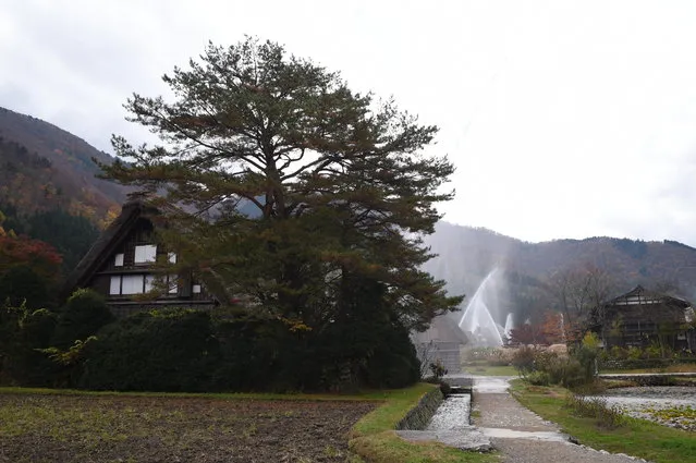 Water is seen discharged over the traditional farm houses at Shirakawa-go, the UNESCO World Heritage site on November 9, 2014 in Shirakawa, Japan. (Photo by Kaz Photography/Getty Images)