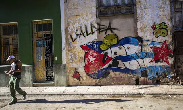 Street art created around the Cuban national flag and the commander in chief military cap of Cuban Revolution leader Fidel Castro is seen in Havana, Cuba, Saturday, August 13, 2016. (Photo by Desmond Boylan/AP Photo)