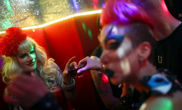 People toast during an after-show party for drag queens and kings in Berlin, Germany, August 27, 2016. Rauschgold, a colourful and crowded place, is famous for its themed parties. (Photo by Hannibal Hanschke/Reuters)