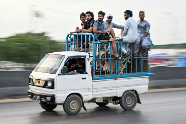 People ferry cattle on a vehicle ahead of the Muslim festival of Eid al-Adha in Karachi on June 3, 2025. (Photo by Rizwan Tabassum/AFP Photo)