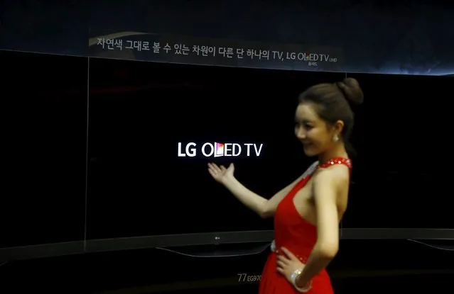 A model poses for photographs with LG Electronics Inc's Super Ultra HD Television sets during its launch event at company's headquarters in Seoul in this February 24, 2015 file photo. South Korea's LG Display Co Ltd said on October 22, 2015 its third-quarter operating profit fell 29.8 percent from a year earlier, missing market expectations, as slowing demand for consumer electronics products hurt panelmakers' pricing power. (Photo by Kim Hong-Ji/Reuters)