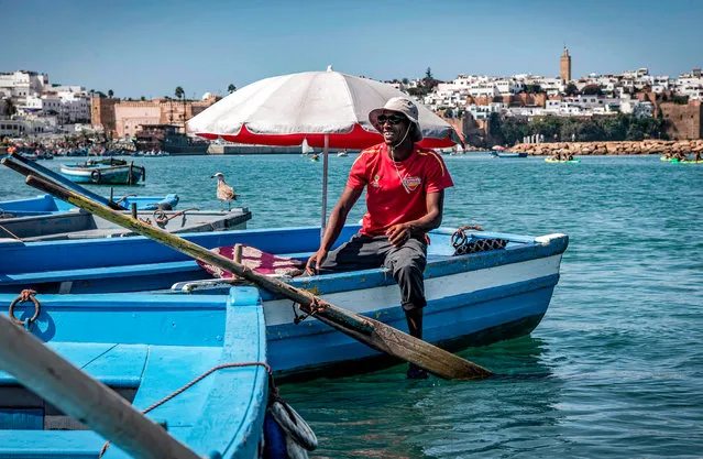 A boatman sits in his boat in the Bou Regreg river between the city of Sale and Morocco's capital Rabat, on September 27, 2020. (Photo by Fadel Senna/AFP Photo)
