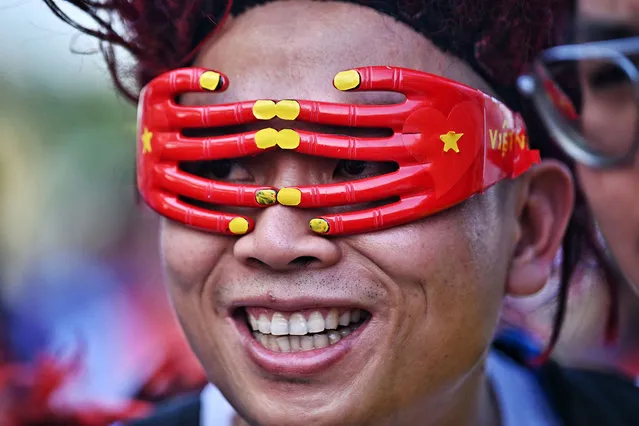 A Vietnamese supporter smiles ahead of the second leg of the AFF Cup final football match between Vietnam and Thailand at Thammasat Stadium in Bangkok on January 16, 2023. (Photo by Lillian Suwanrumpha/AFP Photo)