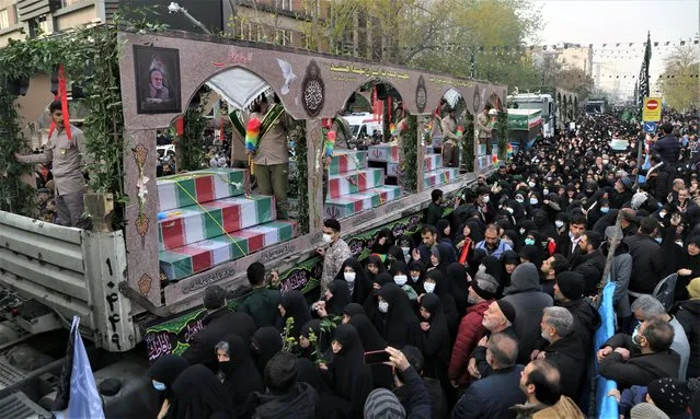 Iranians attend a funeral procession carrying the remains of 200 Iranian soldiers recovered from former battlefields of the Iran-Iraq war (1980-1988) outside University of Tehran on December 27, 2022 in Tehran, Iran. (Photo by Fatemeh Bahrami/Anadolu Agency via Getty Images)