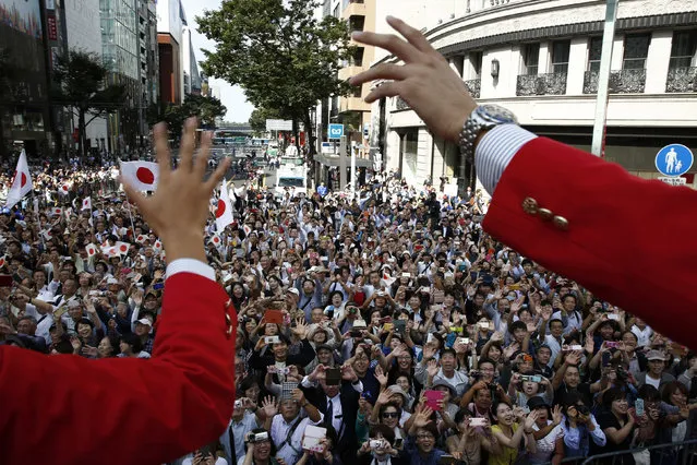 Japanese medalists of Rio de Janeiro Olympics wave from a bus to cheering people during a parade in Tokyo's Ginza district Friday, October 7, 2016. Some 90 medalists took part in the 2.5 kilometers (1.6 mile) motorcade through the streets in Tokyo, the host city of the 2020 Olympics and Paralympics. (Photo by Kim Kyung-Hoon/Pool Photo via AP Photo)