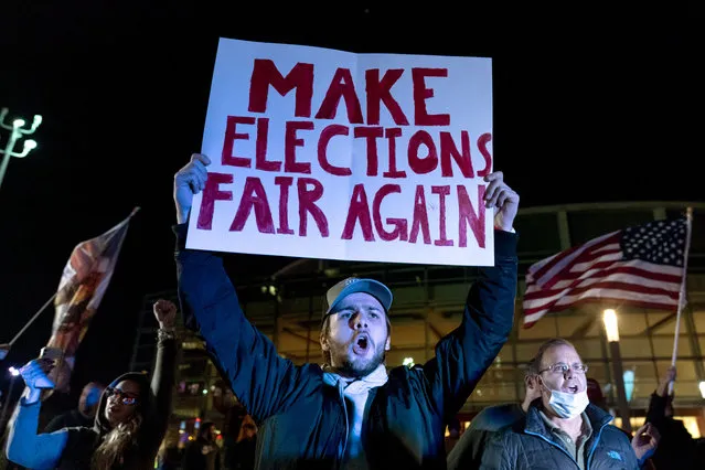 Trump supporter Jake Contos chants during a protest against the election results outside the central counting board at the tcf Center in Detroit, Thursday, November 5, 2020. (Photo by David Goldman/AP Photo)