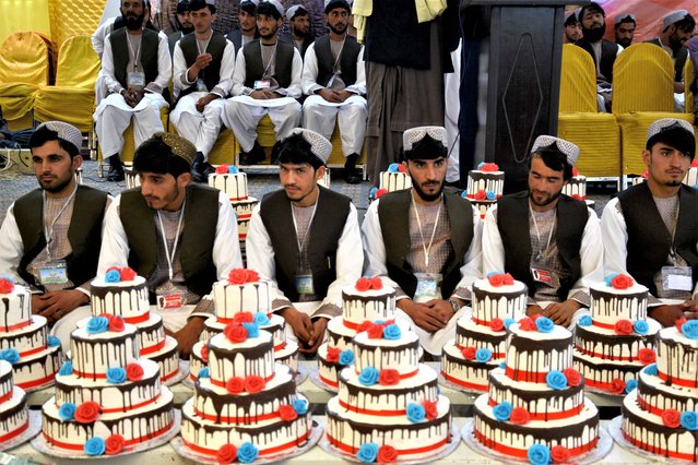 Afghan grooms attend their mass wedding ceremony at a hall in Kandahar on February 28, 2023. (Photo by Sanaullah Seiam/AFP Photo)