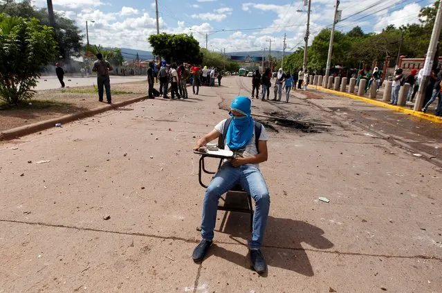 A student sits on a school bench during a protest to demand the resignation of Honduran President Juan Orlando Hernandez in Tegucigalpa, Honduras, November 4, 2015. (Photo by Jorge Cabrera/Reuters)