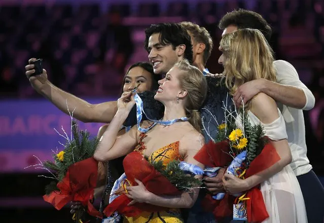Gold medallist Andrew Poje (C) of Canada takes a “selfie” picture with other winners on the podium after the Ice Dance final competition at the ISU Grand Prix of Figure Skating final in Barcelona December 13, 2014. Also on the podium are: fellow gold medallist Kaitlyn Weaver (front) of Canada, silver medallists Madison Chock (L) and Evan Bates (hidden) of the U.S. and bronze medallists (R) Gabriella Papadakis and Guillaume Cizeron of France. (Photo by Gustau Nacarino/Reuters)