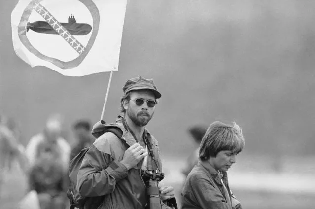 One of the thousand of protesters who took part in an anti Trident rally Sunday, August 9, 1982 displays a flag supporting the movement. Religious leaders denounced the buildup of nuclear weapons as protestors waited on banks, beaches and in boats for the arrival of the nation's first Tridents nuclear submarine. (Photo by AP Photo/BRS)