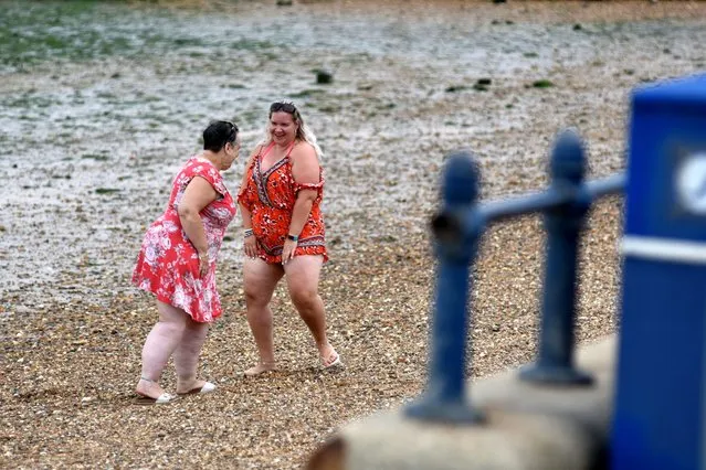 Two women dance on the beach as the sun sets in the evening on August 07, 2020 in Southend on Sea, United Kingdom. Parts of England are enjoying a three-day heatwave with temperatures set to reach up to 38 degrees centigrade in the South East. (Photo by John Keeble/Getty Images)