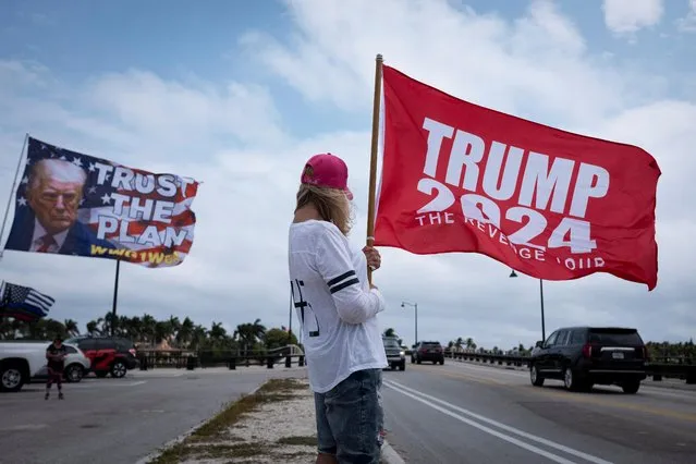 Supporters of former U.S. President Donald Trump gather outside his Mar-a-Lago resort after he posted a message on his Truth Social account saying that he expects to be arrested on Tuesday, and called on his supporters to protest, in Palm Beach, Florida, U.S. March 19, 2023. (Photo by Marco Bello/Reuters)