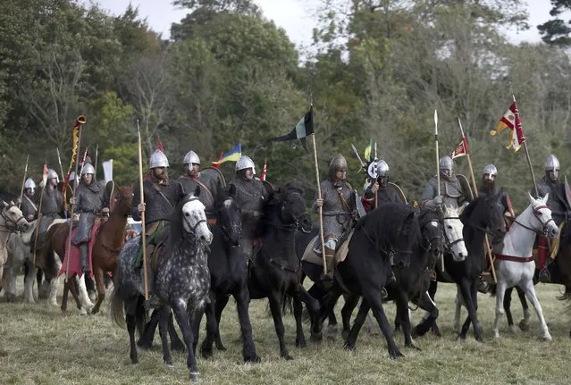 Re-enactors participate in a demonstration before a re-enactment of the the Battle of Hastings on the 950th anniversary of the battle, in Battle, Britain October 15, 2016. (Photo by Neil Hall/Reuters)