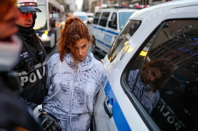 A woman is arrested by the New York City Police Department (NYPD) during a U.S. Immigration and Customs Enforcement (ICE) protest on December 11, 2020 in New York City. The unidentified woman was arrested after driving her car through a group of protesters and then attempting to flee. Several protesters were injured and taken to local hospitals. Protesters were marching in solidarity with ICE detainees on a hunger strike at Bergen County Jail in Hackensack, New Jersey. (Photo by Dia Dipasupil/Getty Images)