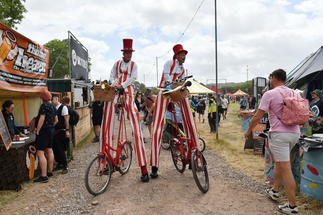 Performers entertain festival goers in the Theatre field during day two of Glastonbury Festival 2024 at Worthy Farm, Pilton on June 27, 2024 in Glastonbury, England. Founded by Michael Eavis in 1970, Glastonbury Festival features around 3,000 performances across over 80 stages. Renowned for its vibrant atmosphere and iconic Pyramid Stage, the festival offers a diverse lineup of music and arts, embodying a spirit of community, creativity, and environmental consciousness. (Photo by Jim Dyson/Redferns)