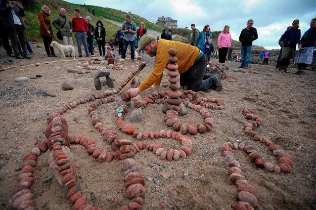 Competitors take part in the European Stone Stacking Championships 2018 in Dunbar, Scotland, on April 22, 2018. (Photo by Andy Buchanan/AFP Photo)