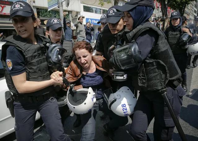 Female police officers detain a woman taking part in May Day protests in Istanbul, Turkey, May 1, 2018. Police detained several demonstrators as the crowd tried to march toward Istanbul's Taksim Square, which is symbolic as the center of protests in which dozens of people were killed in 1977.(Photo by Lefteris Pitarakis/AP Photo)