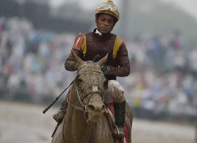 Ricardo Santana Jr. is covered in mud after riding Whitmore in a race before the 144th running of the Kentucky Derby horse race at Churchill Downs Saturday, May 5, 2018, in Louisville, Ky. (Photo by John Minchillo/AP Photo)