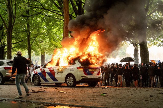 A police car is set on fire during a protest against the current asylum policy on the Malieveld, in the Hague, the Netherlands, 20 September 2025. The initiator, known online as Els Rechts, advocates for less immigration, fair housing policies, and transparency towards the public. (Photo by Josh Walet/EPA)