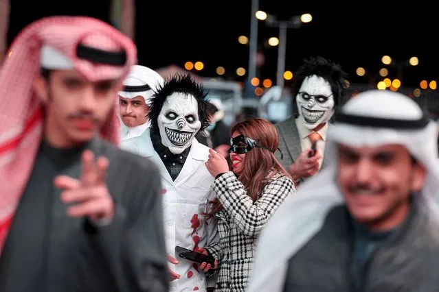 People dressed in costumes walk on a street, as they take part in a two-day costume event in Riyadh, Saudi Arabia, March 17, 2022. (Photo by Ahmed Yosri/Reuters)