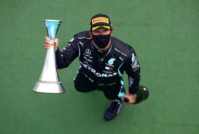 Mercedes' British driver Lewis Hamilton celebrates with the trophy on the podium of the Formula One Hungarian Grand Prix race at the Hungaroring circuit in Mogyorod near Budapest, Hungary, on July 19, 2020. (Photo by Mark Thompson/Reuters)