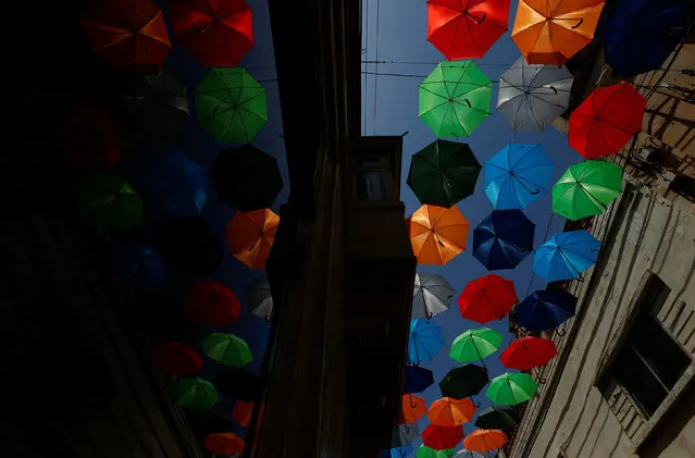 A canopy of coloured umbrellas hangs over a street in preparation for a music festival at the weekend, in Zabbar, Malta June 5, 2018. (Photo by Darrin Zammit Lupi/Reuters)