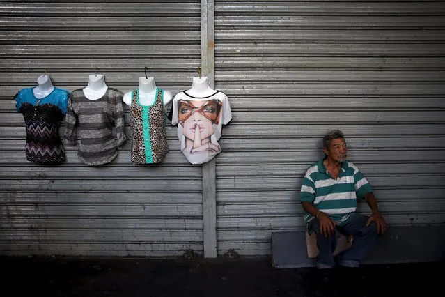 A man sells clothes on the street, in the Caracas downtown December 4, 2015. (Photo by Nacho Doce/Reuters)