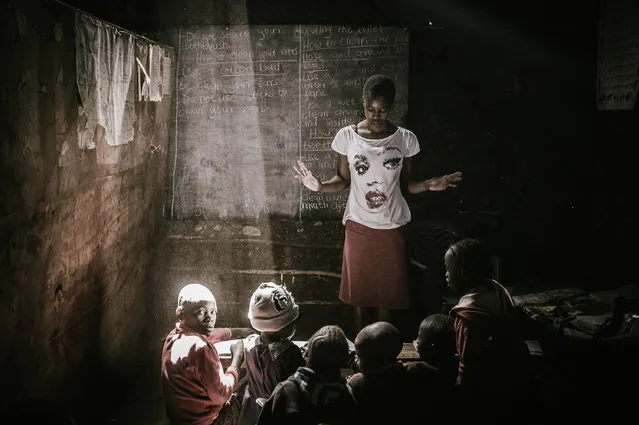 “Kibera Class”. This picture is taken in a “classroom” in Kibera, the second largest urban slum in Africa, while working for “Sarakasi Trust”. This non-profit performing arts development organization believes in the use of Culture for Development and the positive role that culture can play to eradicate poverty. (Photo and caption by Luc Vekemans/National Geographic Traveler Photo Contest)