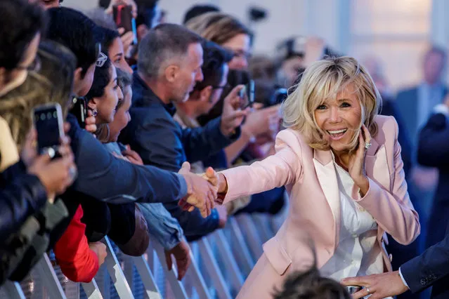 Brigitte Macron, the wife of the French president, greets people during the “Fete de la Musique”, the music day celebration in the courtyard of the Elysee Palace, in Paris, France, June 21, 2018. (Photo by Christophe Petit Tesson/Pool via Reuters)
