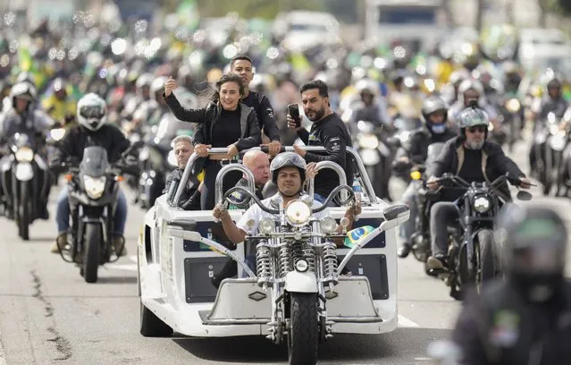 Supporters of Brazil's President Jair Bolsonaro take part in a caravan of thousands of motorcycle enthusiasts who gathered in a show of support for him in Sao Paulo, Brazil, Friday, April 15, 2022. (Photo by Andre Penner/AP Photo)