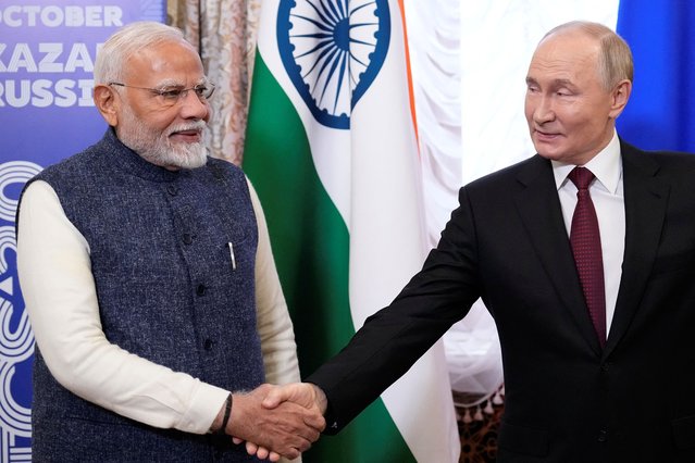 Russian President Vladimir Putin, right, and Indian Prime Minister Narendra Modi shake hands during their meeting on the sidelines of BRICS Summit at Kazan Kremlin in Kazan, Russia, Tuesday, October 22, 2024. (Photo by Alexander Zemlianichenko/Pool via AP Photo)