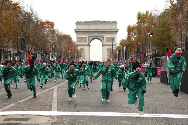 Participants runs as they take part in a game based on Netflix's South Korean TV show “Squid Game” ahead of the launch of Season 2, on the Champs Elysees Avenue in Paris on December 1, 2024. (Photo by Alain Jocard/AFP Photo)
