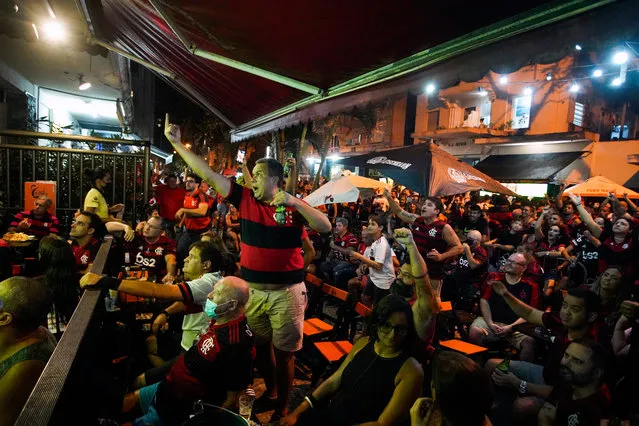Fans of Flamengo gather in a bar to watch on a big screen the match between Sao Paulo and Flamengo as part of 2020 Brasileirao Series A at Copacabana neighborhood on February 25, 2021 in Rio de Janeiro, Brazil. The match takes place at Morumbi Stadium in Sao Paulo. (Photo by Wagner Meier/Getty Images)