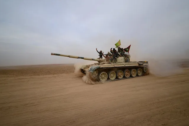 Shi'ite fighters ride on a tank heading toward the airport of Tal Afar during a battle with Islamic State militants in Tal Afar west of Mosul, Iraq, November 16, 2016. (Photo by Reuters/Stringer)