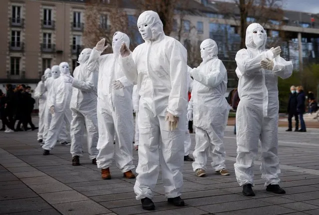 Activists of the “white masks” group (les masques blancs), who denounce the COVID-19 health restrictions measures to fight the coronavirus disease outbreak in France, attend a demonstration against the “global security bill” in Nantes, France, March 16, 2021. (Photo by Stephane Mahe/Reuters)