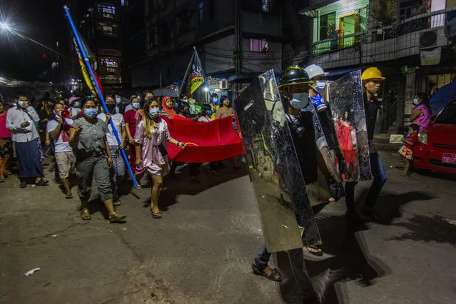 Residents march around their neighborhood despite an overnight curfew in an anti-coup night rally at the Myaynigone area of Sanchaung township in Yangon, Myanmar Monday, March 15, 2021. Myanmar's ruling junta has declared martial law in a wide area of the country's largest city Yangon, as security forces killed dozens of protesters over the weekend in an increasingly lethal crackdown on resistance to last month's military coup. (Photo by AP Photo/Stringer)