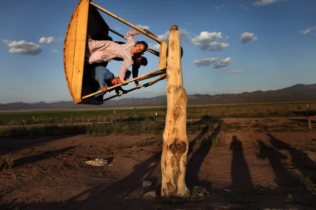 2010 Visa d'or Feature: Stephanie Sinclair. After helping bring in the hay harvest, Amber Barlow, 16, a member of the Fundamentalist Church of Jesus Christ of Latter Day Saints, FLDS, soars on a homemade swing with friends at the 4,000-acre FLDS ranch, in Pony Springs, near Pioche, Nev. on Aug. 14, 2009. (Photo by Stephanie Sinclair/VII)