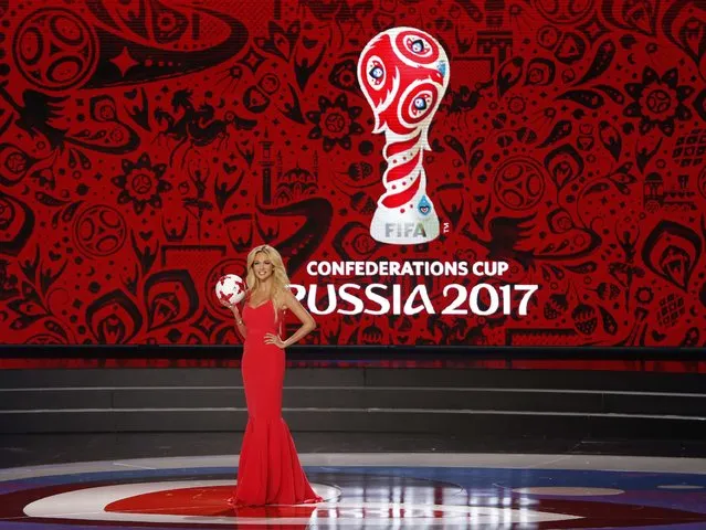 The official representative of the 2018 Football World Cup Victoria Lopyreva, arrives on stage with the offical football at the group draw of the Confederations Cup 2017 at the tennis academy in Kazan, Russia, 26 November 2016. (Photo by Maxim Shemetov/Reuters)