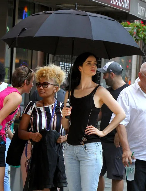 Krysten Ritter seen holding an umbrella, trying to brave the hot temperatures as she films scene with Rachael Taylor at the “Jessica Jones” set in Downtown, Manhattan on August 28, 2018. (Photo by Jose Perez/Splash News and Pictures)