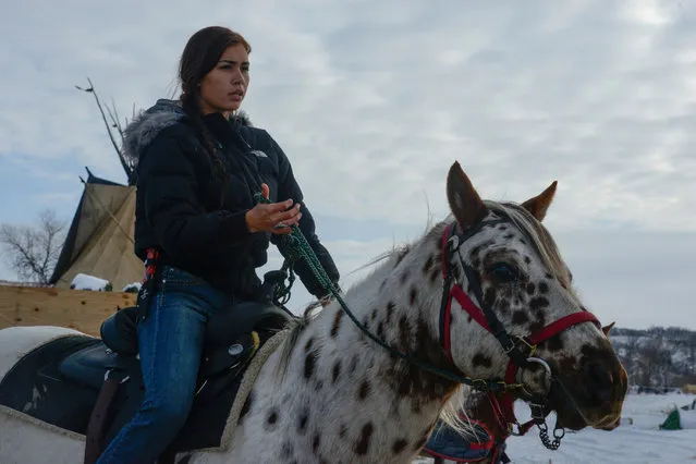 Waskoness Pitswanakwat, 16, rides her horse in Oceti Sakowin camp during a protest against plans to pass the Dakota Access pipeline near the Standing Rock Indian Reservation, near Cannon Ball, North Dakota, U.S. December 2, 2016. (Photo by Stephanie Keith/Reuters)