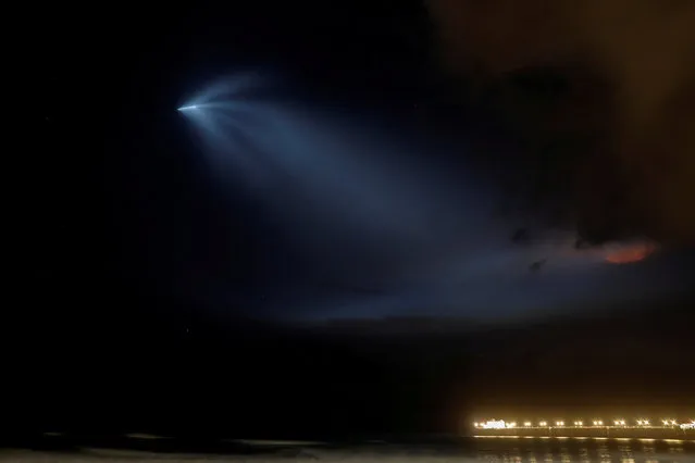 A SpaceX Falcon 9 rocket lights up the evening sky over Oceanside, California as it carries an Argentinian Earth-observing satellite into space after blasting off from Vandenberg Air Force Base, California, U.S., October 7, 2018. (Photo by Mike Blake/Reuters)