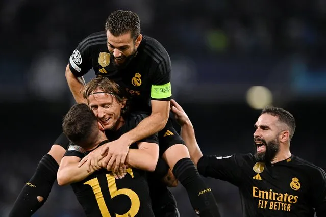 Real Madrid players celebrate after Alex Meret of Napoli (not pictured) scores an own goal and Real Madrid's third goal during the UEFA Champions League match between SSC Napoli and Real Madrid CF at Stadio Diego Armando Maradona on October 03, 2023 in Naples, Italy. (Photo by Francesco Pecoraro/Getty Images)